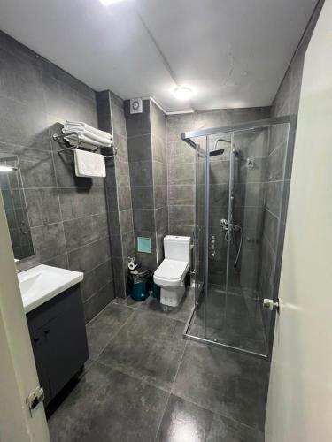 a bathroom with a shower and a toilet and a sink at Vicolo Moda Kadıköy in Istanbul