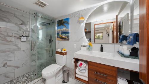 a bathroom with a shower and a toilet and a sink at Spectacular luxury , modern oceanfront condo Maalaea-Kihei ,Maui in Wailuku