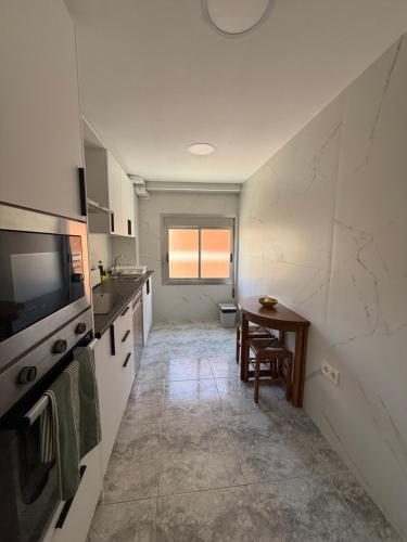 a kitchen with a sink and a table in it at Zapillo 2&1 in Almería