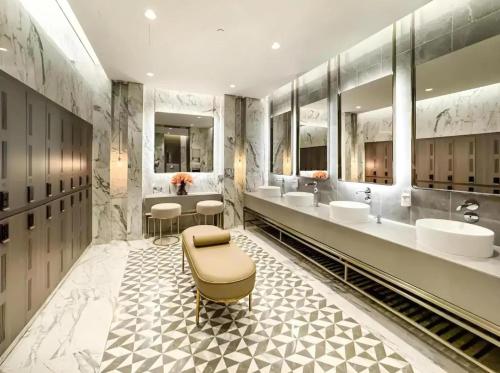 a bathroom with three sinks and two sinksktop at Downtown Dubai's Highest Infinity Pool, Paramount Hotel Midtown in Dubai