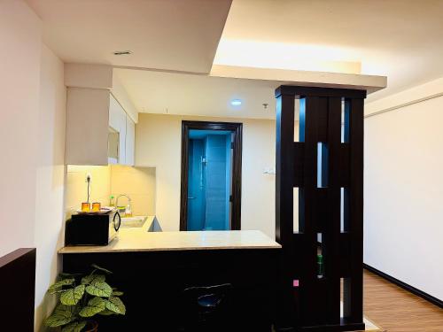 a kitchen with a counter and a blue door at EasyStay Studio Apartment KBCP in Kota Bharu