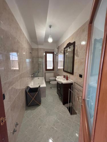 a bathroom with a tub and a sink and a toilet at Respiro di luna in Pescopagano