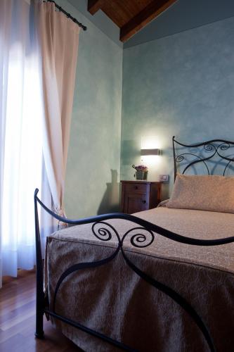 a bedroom with a bed and a window at Relais Casa Orter in Risano