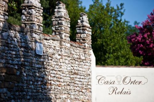 a stone wall with two towers on top of it at Relais Casa Orter in Risano
