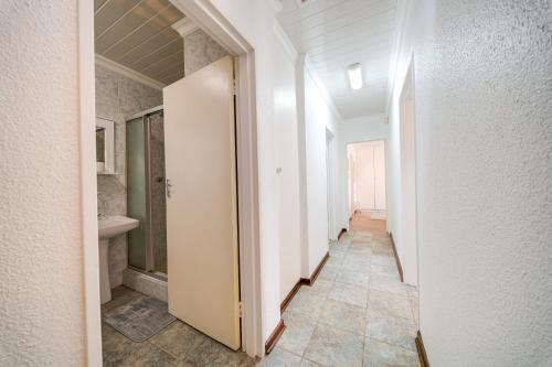 a hallway of a bathroom with a toilet and a sink at 3 Italeni in Secunda