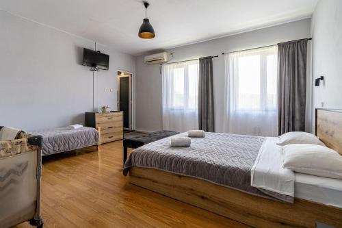 a bedroom with two beds and a television in it at Boutique Hotel Ilitsa in Gavril Genovo