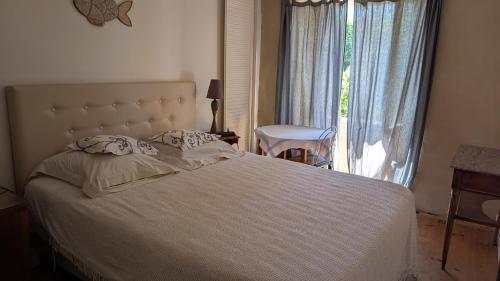 a bedroom with a bed and a large window at Méréhenc in Plouha