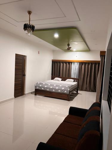 a bedroom with a bed and a couch in it at Beach Residency in Kāsarkod