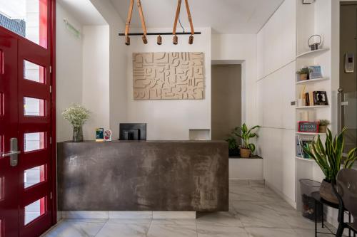 a lobby with a bench in the middle of a room at DownTown Hotel in Nafplio