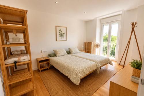 a bedroom with a bed and a window at Rivera de Poulo in Ordes