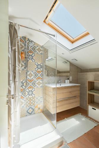 a bathroom with a glass shower and a sink at Maison de campagne in Aubagne