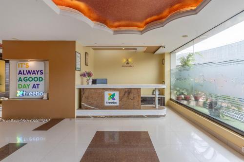 a lobby of a store with a sign that reads always approved day art at Treebo Premium Raj Elegance Manyata Tech Park in Bangalore
