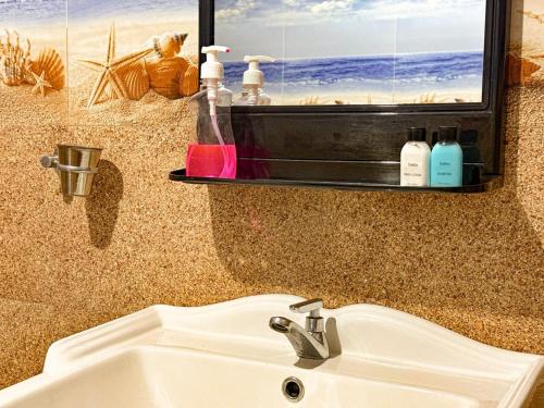 a bathroom with a sink and a mirror and a sink at Tera Ella Boutique Hotel by SANS in Ella