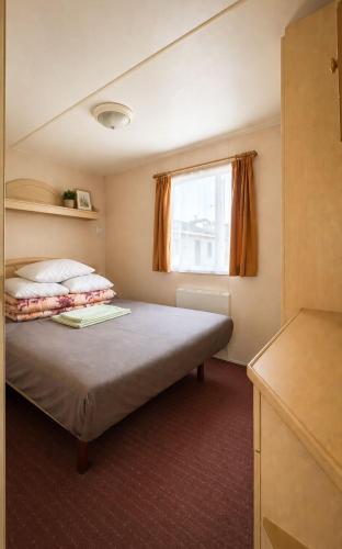 a bedroom with a large bed with a window at Rowyhills in Rowy