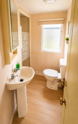 a bathroom with a sink and a toilet at Rowyhills in Rowy