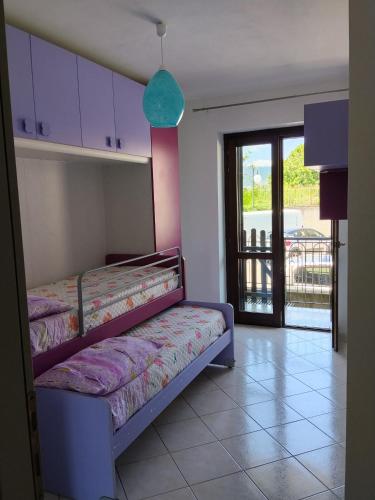 a bedroom with two bunk beds and a balcony at Casa Vacanze Daniele in Pontecagnano