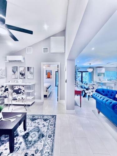 a living room with a blue couch and a table at The Miami Grove Oasis in Miami
