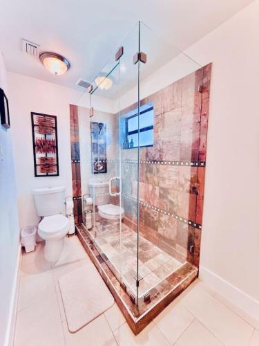 a bathroom with a shower and a toilet at The Miami Grove Oasis in Miami