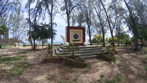 a monument in the middle of a park with trees at Allamanda Apartments - 100m Bain Boeuf Beach in Bain Boeuf
