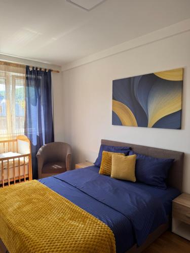 a bedroom with a bed and a painting on the wall at Apartman Lambros 2 in Soko Banja