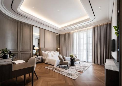 a bedroom with a bed and a desk and a couch at Hotel Fairmounts Plaza Near IGI International Airport Delhi in New Delhi