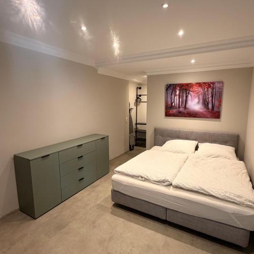 a bedroom with a bed and a painting on the wall at Apartment MessePark Bad Salzuflen in Bad Salzuflen