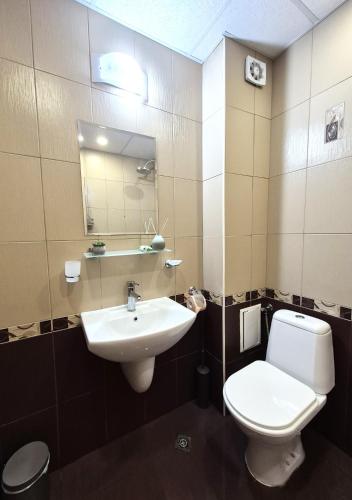 a bathroom with a sink and a toilet and a mirror at Seaside Dream in Dolen Bliznak