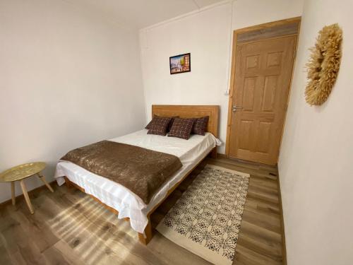a bedroom with a bed and a wooden door at villa POOJA in Cap Malheureux