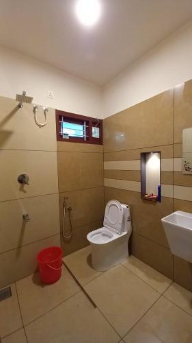 a bathroom with a toilet and a sink at Kodikkakkam Homestay in Kappil