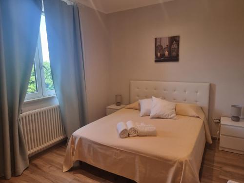 a bedroom with a bed with two towels on it at Rosmat's house in Conversano