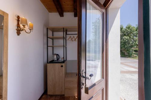 a door leading into a room with a glass doorway at Ca' Tessera Venice Airport in Tessera