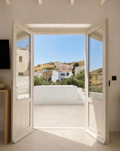 an open door to a balcony with a view at Dryope Luxury Living in Dhriopís