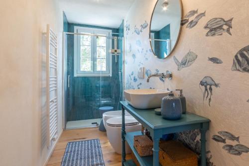 a bathroom with a sink and a mirror on the wall at Charme Villa La Vela - Goelba in Lacona