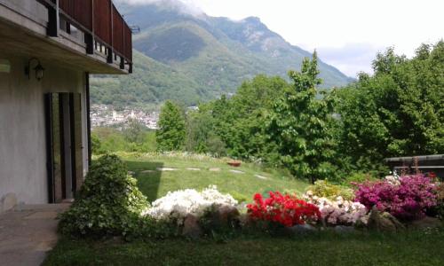 a house with a garden with flowers in the yard at Residence Joy Center in Villar Pellice