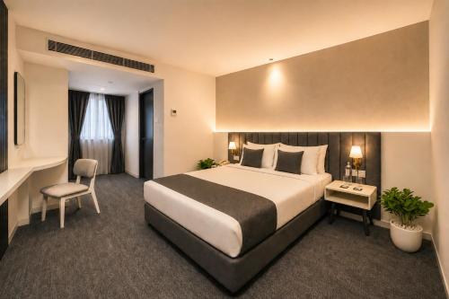a hotel room with a large bed and a chair at S by Z Hotels, HSR in Bangalore