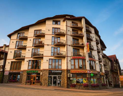 a large building with balconies on a street at SPA Resort HeRICH in Bukovel