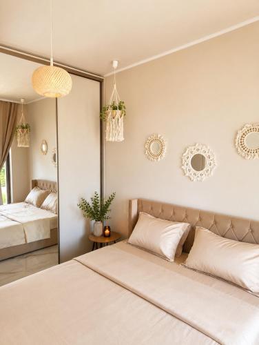 a bedroom with two beds and a mirror at Amore Fanari in Fanari