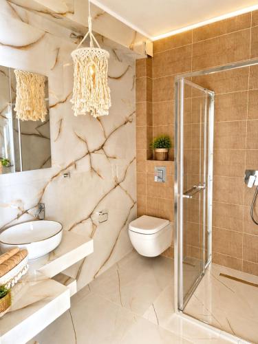 a bathroom with a sink toilet and a shower at Amore Fanari in Fanari