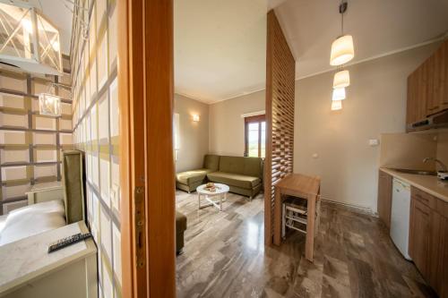 a kitchen and living room with a couch and a table at Ariadnes Holiday Accommodation in Apidias Lakos