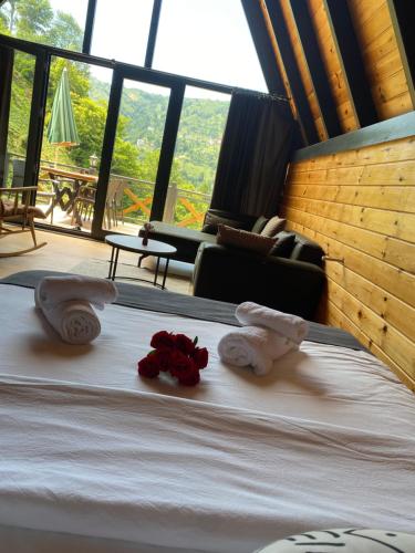 a bedroom with a bed with towels and roses on it at Varya Tatil Köyü in Çamlıhemşin