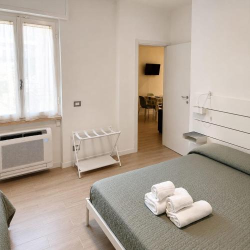 a bedroom with a bed with towels on it at Bolle Apartment Monterosso al mare in Monterosso al Mare