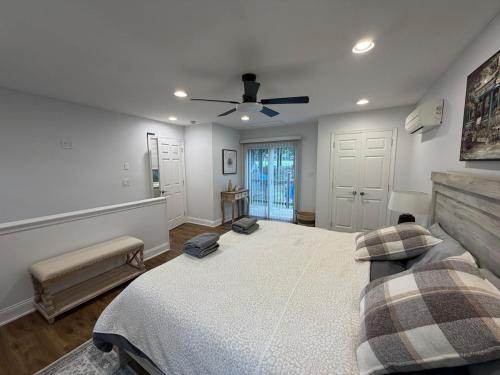 a bedroom with a large bed and a ceiling fan at Poconos Hideaway in Greentown