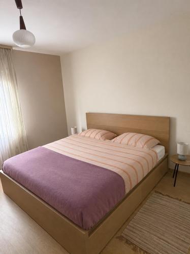 a bedroom with a large bed with pink pillows at Ferienwohnung Grebe in Breidenbach