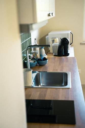 a kitchen counter with a sink and a coffee maker at Masseria Marchesani in Montenero di Bisaccia