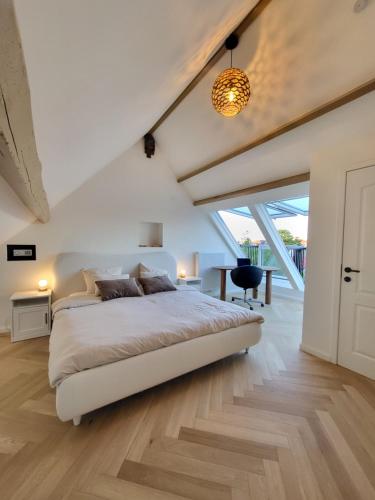 a bedroom with a large bed in a room at Castle-grounds house with rooftop view & jacuzzi in Ghent