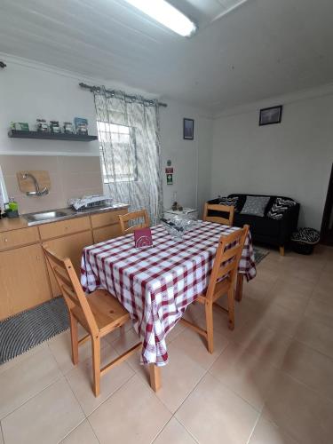 a kitchen with a table and chairs in a room at Casa Vale Frio in Calheta