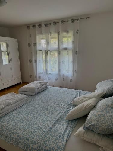 two beds in a bedroom with two pillows at BrusNica in Gornji Milanovac
