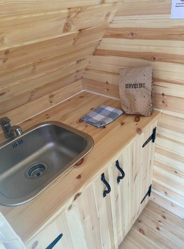 a sink in a bathroom in a tiny house at Rustical deluxe - Hexenhäuschen in Echternacherbrück