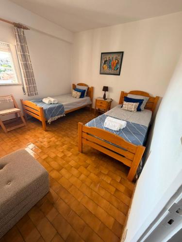 a living room with two beds and a couch at Marachique Beach Flat in Alvor