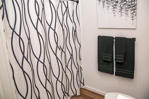 a bathroom with a black and white wall with towels at The View at Harbor Lights in Hammondsport